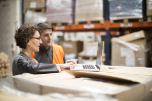 Warehouse workers updating their inventory system.