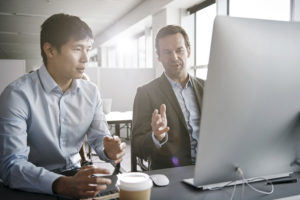 Two guys looking at web hosting plans